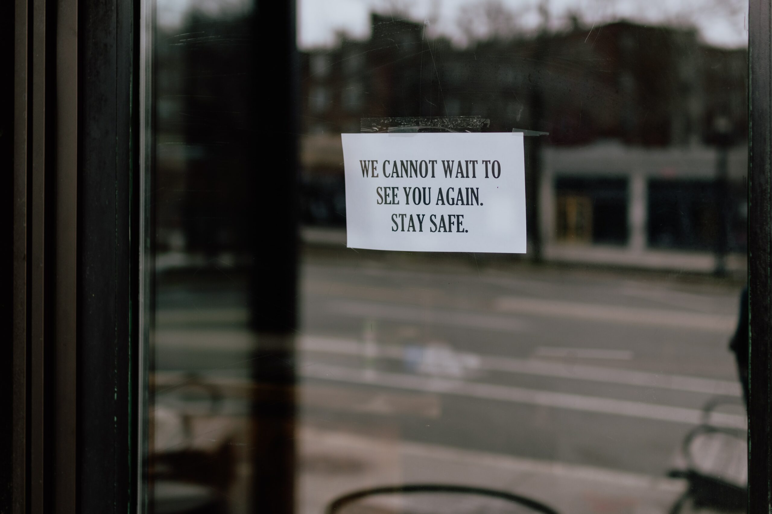 note on window saying we cannot wait to see you again. stay safe