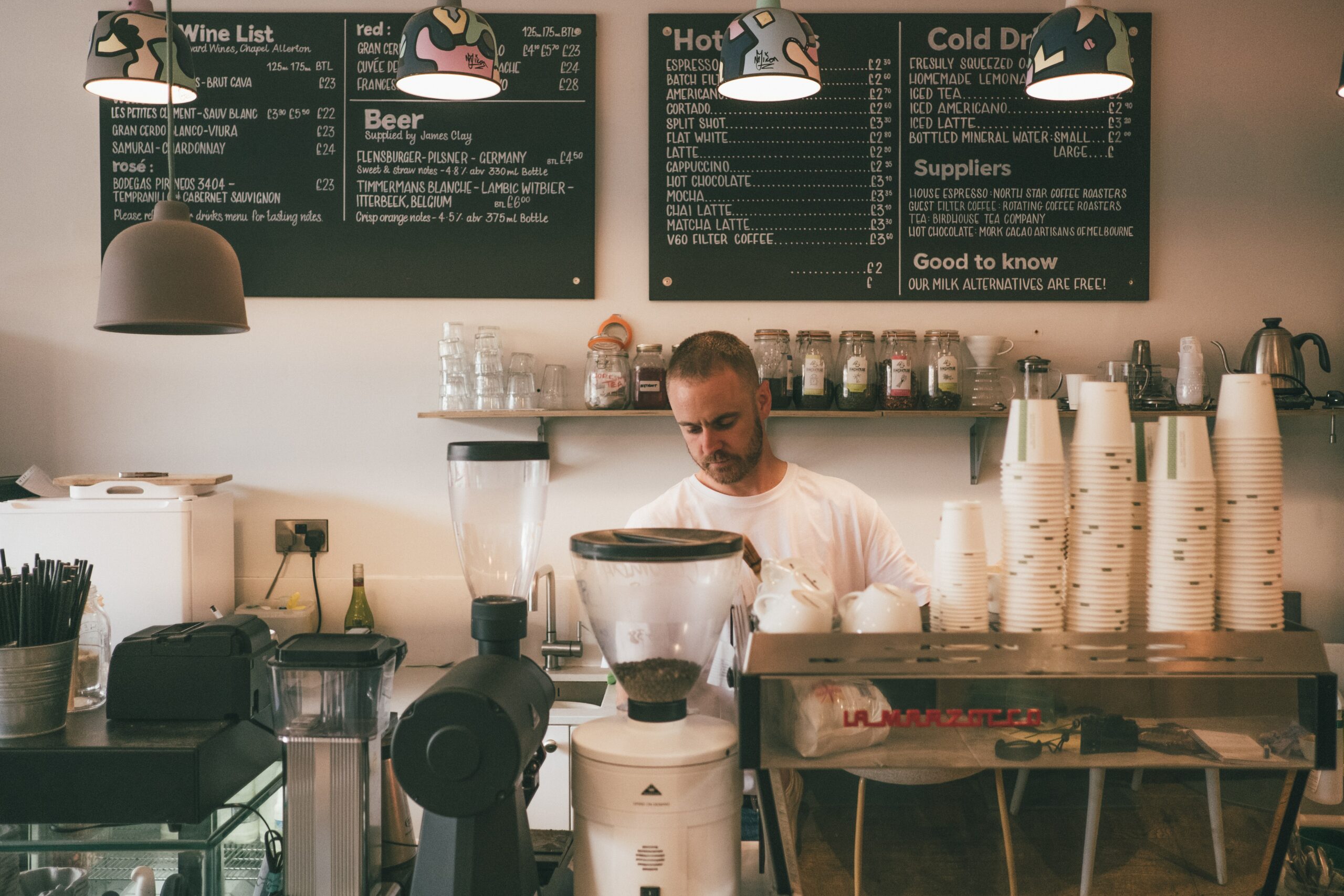 man making coffee in coffee shop