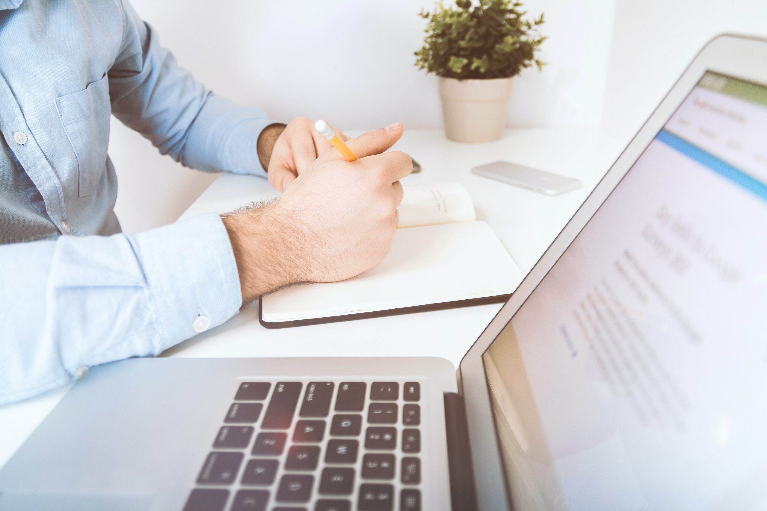 man at desk working and writing