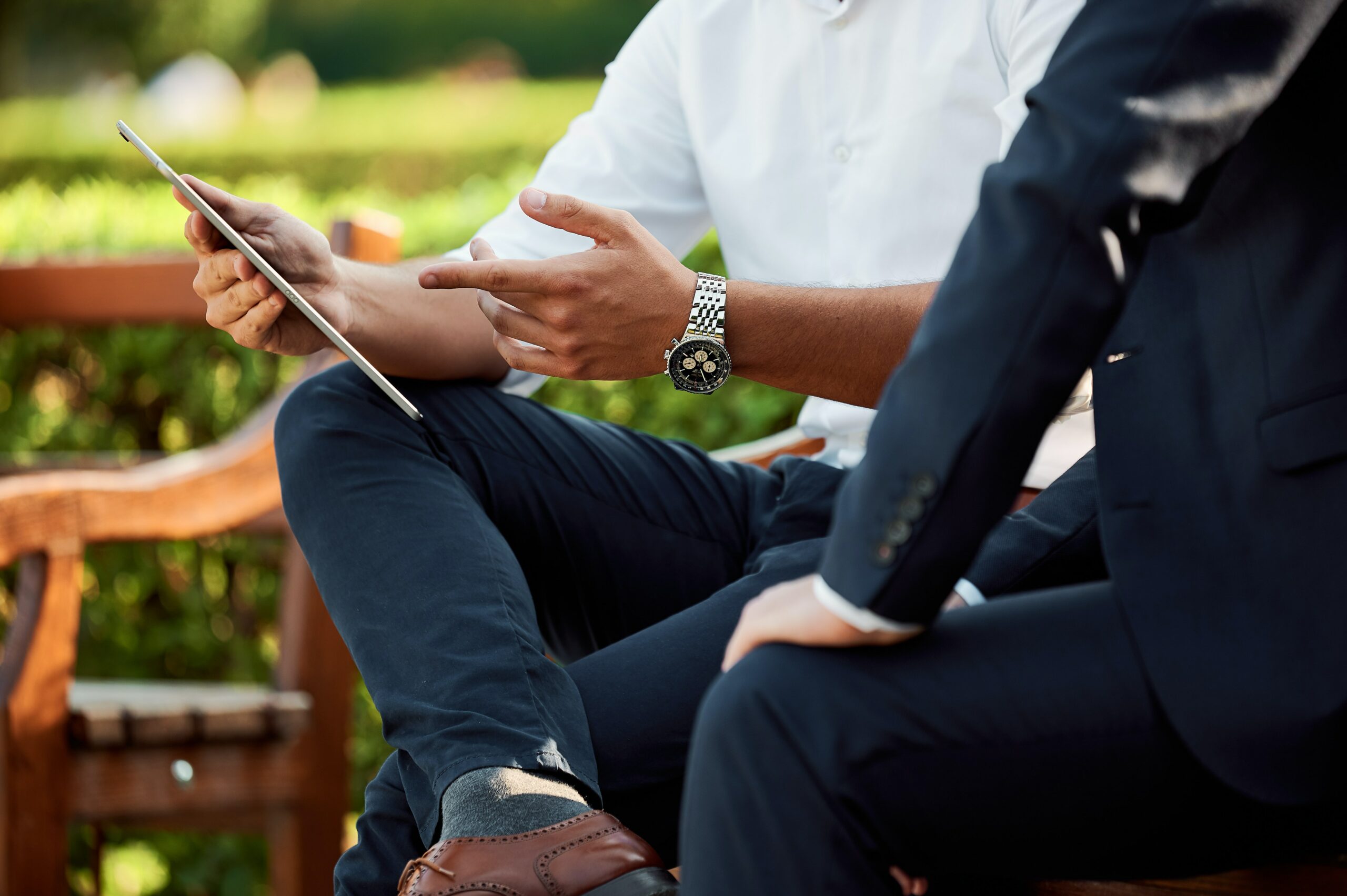 man and women speaking on london park bench