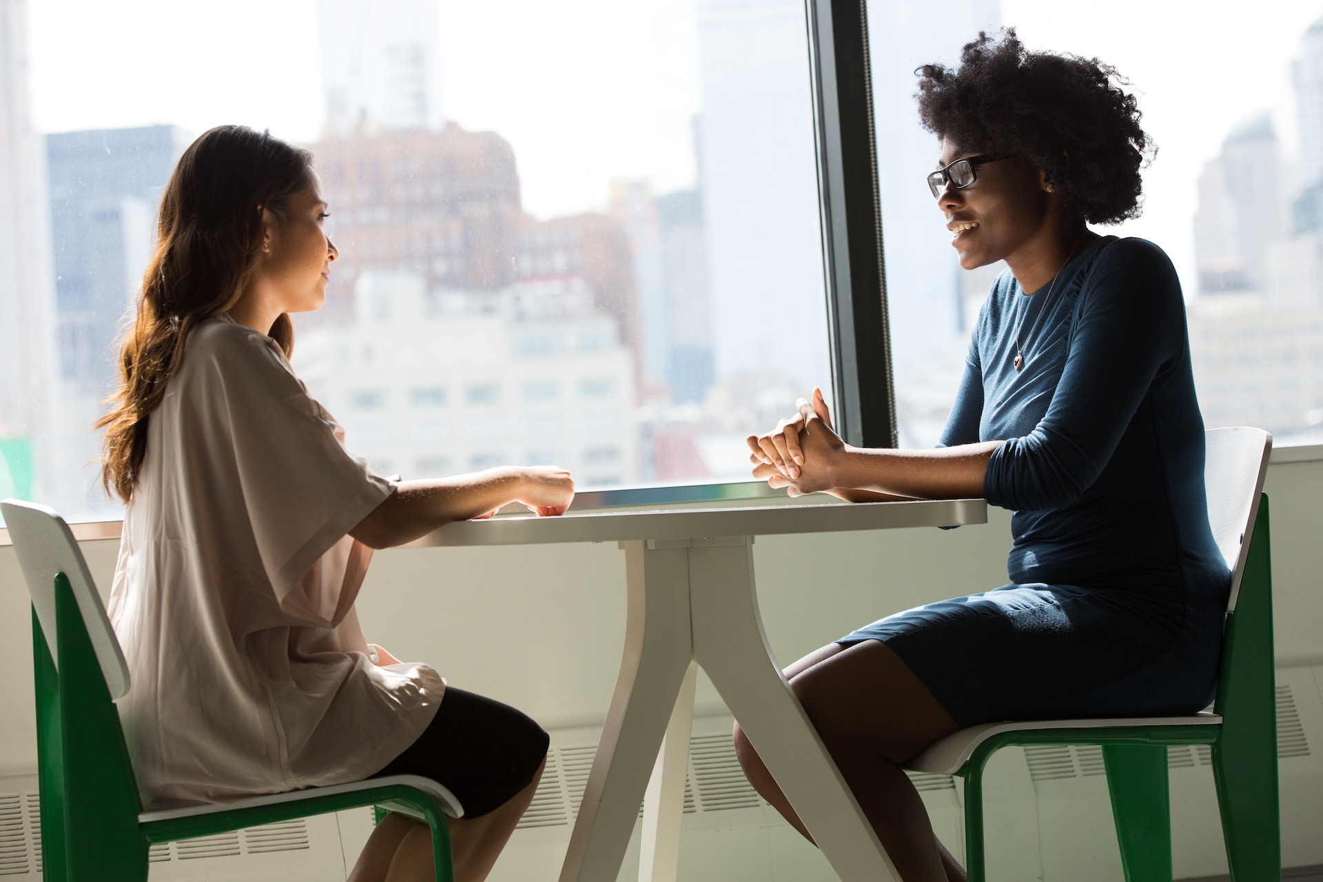 2 women talking over coffee table